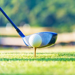 Driver ready to hit golf ball on a tee