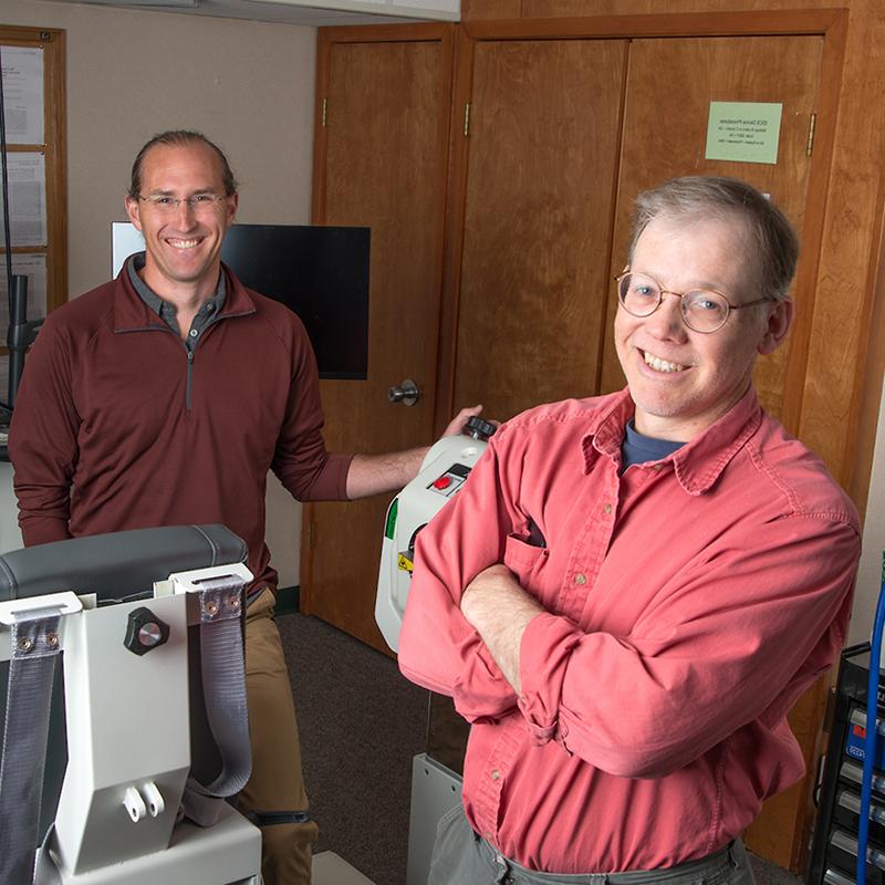 Professors pose in a lab